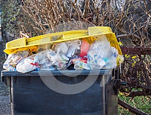 Garbage can with plastic waste