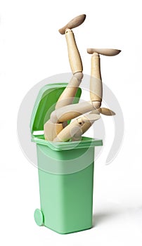 Garbage Can with a Wooden Figure