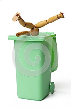 Garbage Can with a Wooden Figure