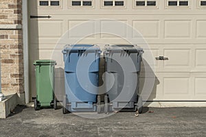 Garbage cans near garage doors