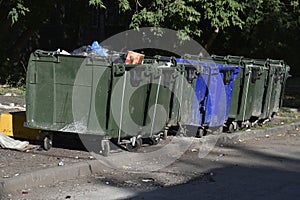 Garbage cans in the urban area and a landfill. Plastic garbage containers in the village