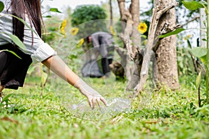 garbage collection, volunteer team picking up plastic bottles, putting garbage in black garbage bags to clean up at parks,