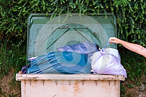 Garbage container full of bags