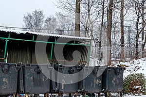 Garbage containers on the background of a sagging canopy. Place to collect garbage