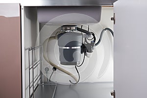 Garbage Disposal under the modern sink, waste chopper concept photo