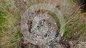 garbage dump in forest. Ecological Problem. Illegal garbage dump in the middle of spring forest. Aerial top view. A pile