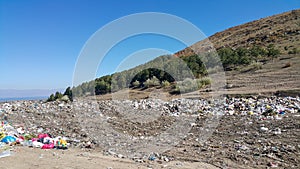 Garbage dump near the forest in nature. Social issues related to environmental protection. Pollution of nature