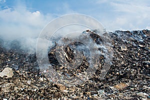 Garbage dump zone landscape view full of smoke, litter, plastic bottles,rubbish and other trash at the Thilafushi tropical island