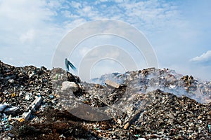 Garbage dump zone view full of smoke, litter, plastic bottles,rubbish and trash at the Thilafushi local tropical island