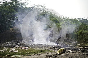 Garbage Dumping and burning site creating air pollution by smoke, pollution control day, land pollution, Raipur, india, Pollution