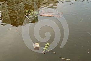 Garbage floating on the river for the concept of water pollution