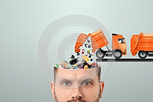 Garbage in the head, clogging up the head with unnecessary information. Garbage truck unloads garbage into the head