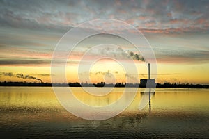 Garbage incineration plant smokestack at sunrise. Environmental pollution