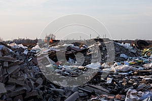 Garbage on the landfill and working bulldozer