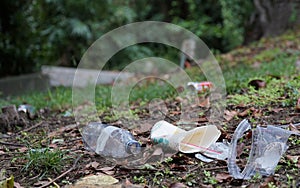 Garbage or litter food containers spread in the park polluting the environment .