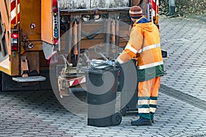 Garbage man collecting the bins