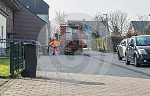 Garbage man collecting the bins