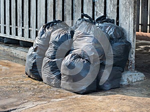 Garbage is packed in black plastic bags.