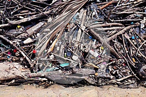 Garbage pile deposit Branches wood, Pile of wood and plastic bottles waste and debris floating on water surface at river water