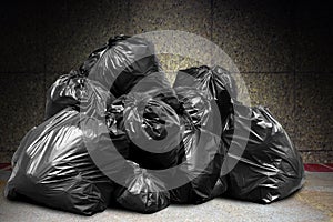 Garbage is pile lots dump, many garbage plastic bags black waste at concrete wall, pollution from trash plastic waste garbage bag