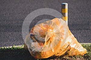 Garbage plastic bag lying on the side of road. oncept of environmental problems