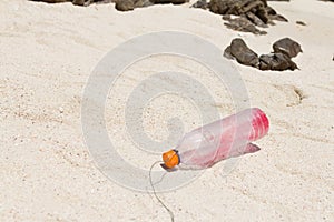 The garbage  plastic bottle was litter on sand beach