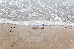 Garbage and plastic bottles and dirty waste on a beach, Concept Campaign to stop using
