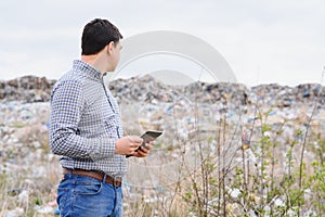 Garbage recycling concept. man on dumpster. Keeping the environment clean. Ecological problems