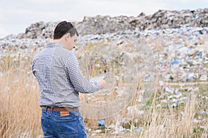 Garbage recycling concept. man on dumpster. Keeping the environment clean. Ecological problems