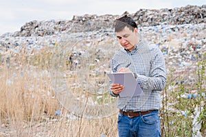 Garbage recycling concept. man on dumpster. Keeping the environment clean. Ecological problems