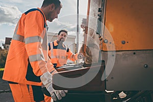 Garbage removal men working for a public utility