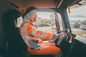 Garbage removal worker driving a dump truck