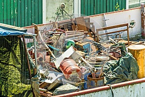 Garbage, scrap and waste in an ugly dirty garbage container on a no longer seaworthy ship in the port