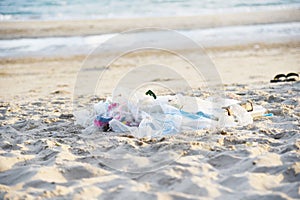 Garbage in the sea with bag plastic bottle and other garbage beach sandy dirty sea on the island / Environmental problem of