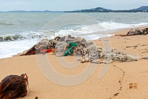 Garbage on sea beach, dirty ocean water, environmental pollution, ecology, waste, rubbish, plastic, trash, refuse, litter