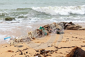 Garbage on sea beach, dirty ocean water, environmental pollution, ecology, waste, rubbish, plastic, trash, refuse, litte