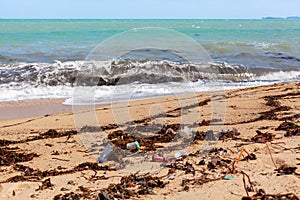 Garbage on sea beach, unsorted rubbish, plastic, glass bottle, metal can, trash, refuse, litter, environmental pollution, ecology
