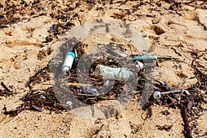 Garbage on sea beach, unsorted rubbish, plastic, glass bottle, metal can, trash, refuse, litter, environmental pollution, ecology