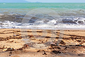 Garbage on sea beach, unsorted rubbish, plastic, glass bottle, metal can, trash, refuse, litter, environmental pollution, ecology