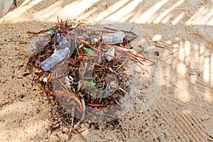 Garbage on sea beach, unsorted rubbish, plastic, glass bottle, metal can, trash, refuse, litter, environmental pollution, ecology