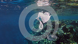 garbage in the sea. Plastic pollution of the sea. used, white plastic bags slowly drifting over the coral reef