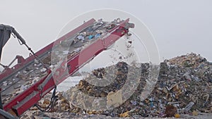 Garbage on shredding line at landfill at winter, Russia