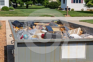 Garbage, trash or waste dumpster full of household junk.