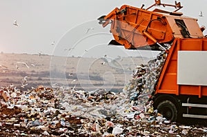 Garbage truck dumping the garbage photo