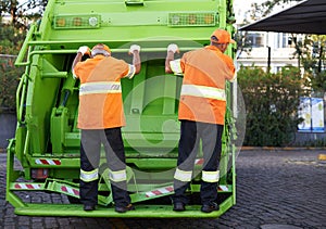 Garbage truck, men and service for waste management and teamwork with routine and cleaning the city. Employees, recycle