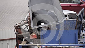 Garbage truck picking container with trash. Rubbish collection vehicle loading garbage in an urban town.