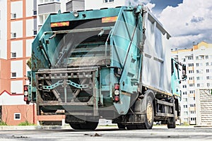 A garbage truck picks up garbage in a residential area. Loading mussar in containers into the car. Separate collection and