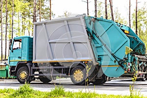 A garbage truck picks up garbage in a residential area. Loading mussar in containers into the car. Separate collection and
