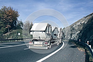 Garbage truck removes construction debris containers