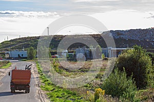 Garbage truck on the road to a dump area.